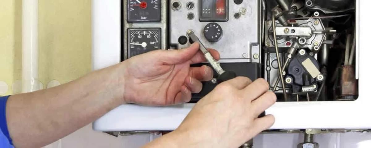 Heating repair technician adjusting boiler controls and components in Cherry Hill, NJ